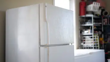 A refrigerator in the garage.