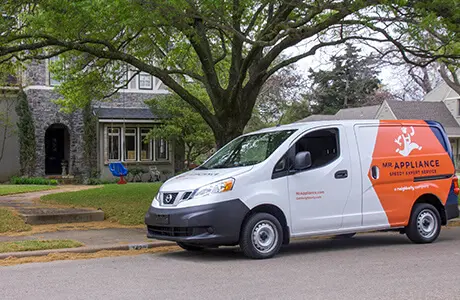 Mr. Appliance branded van parked outside residential home.