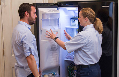 Technician explaining the repairs required for their freezer.