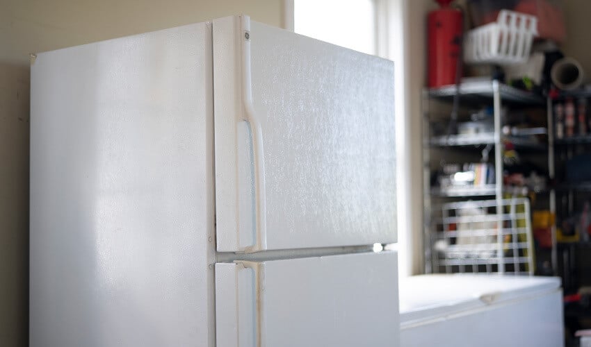 A refrigerator in the garage.