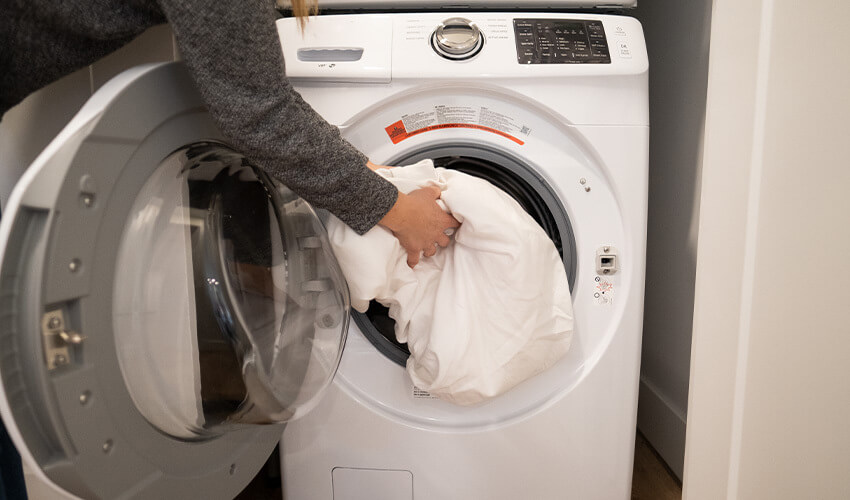 Putting laundry in washing machine