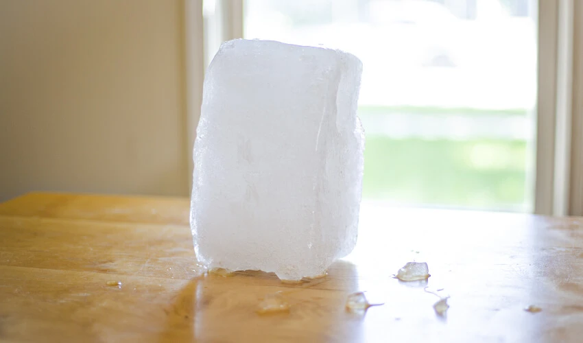 A block of ice on a kitchen table.