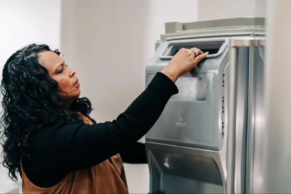 woman examining ice maker