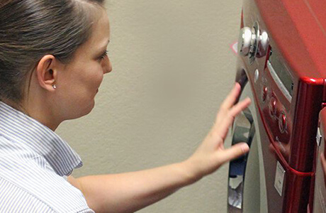 A technician troubleshooting a washer unit.