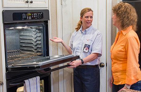 Tech Explaining Oven Repair to Customer