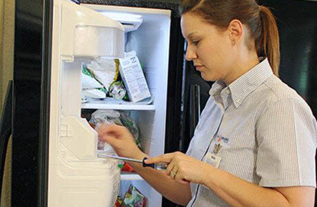 Technician completing an ice machine repair.