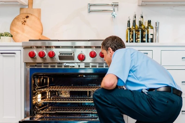 Mr. Appliance tech working on oven repair.